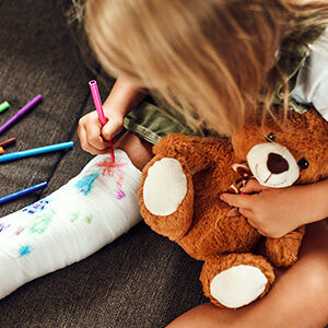 Little girl with a broken leg on the couch
